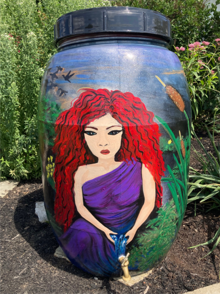 photo of rain barrel painted like a red haired women.